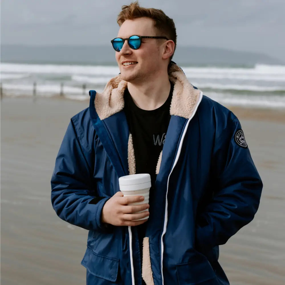 Navy Cobe changing robe: shearling-lined bomber jacket with reflective sunglasses