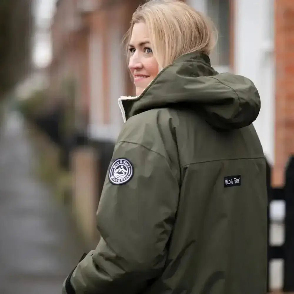 Olive green changing robe puffer jacket with white fur trim