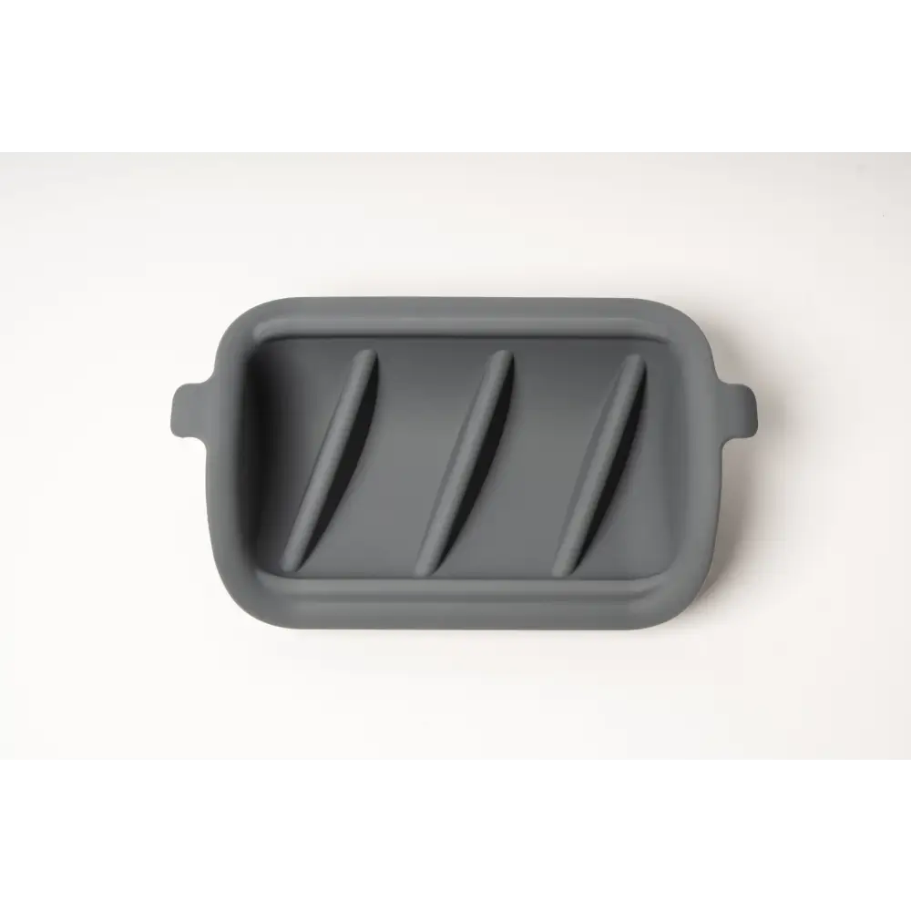 Gray silicone slow feeder insert with diagonal grooves and rounded handles