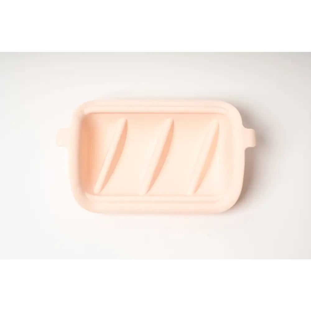 Pastel pink silicone slow feeder baking dish with handles