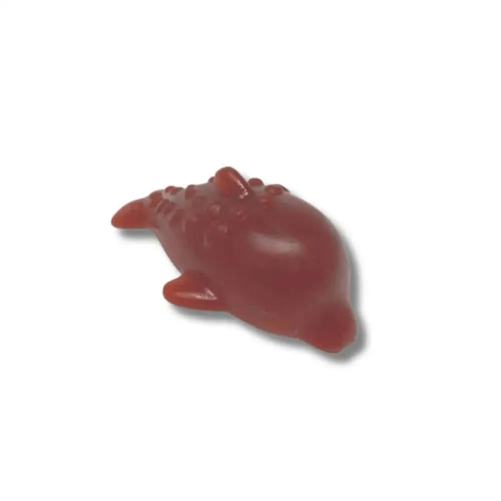Red dolphin-shaped bath bomb with textured surface and glossy finish from Banana Dolphin Vegetable line
