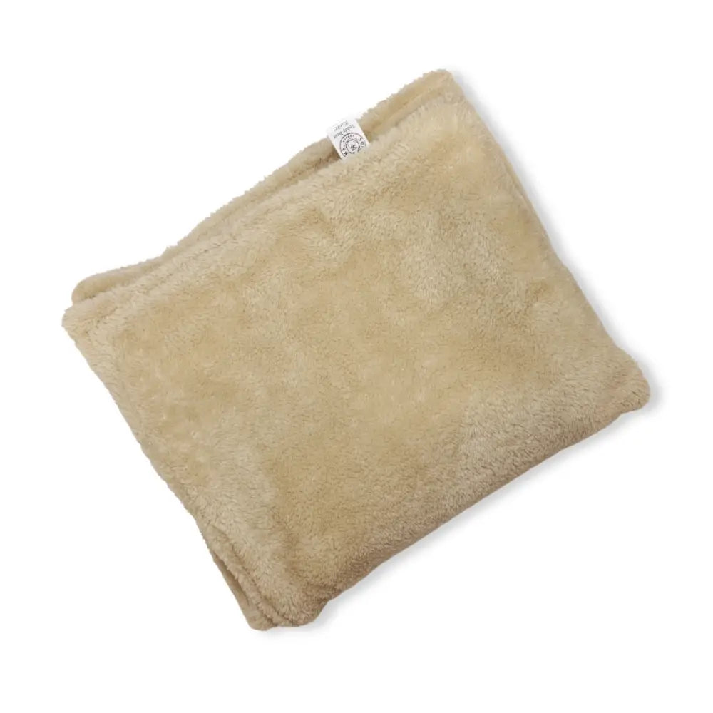 Beige plush dog blanket by Soho Poms with soft fuzzy texture and white tag