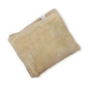 Beige plush dog blanket by Soho Poms with soft fuzzy texture and white tag