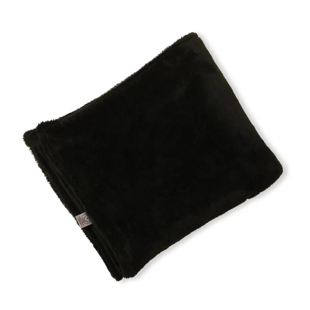 Black plush dog blanket by Soho Poms with soft fuzzy texture and small logo detail