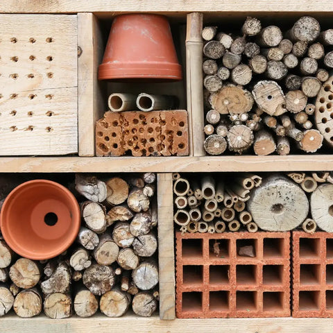 Insect hotel built from wood, flower pots and bricks