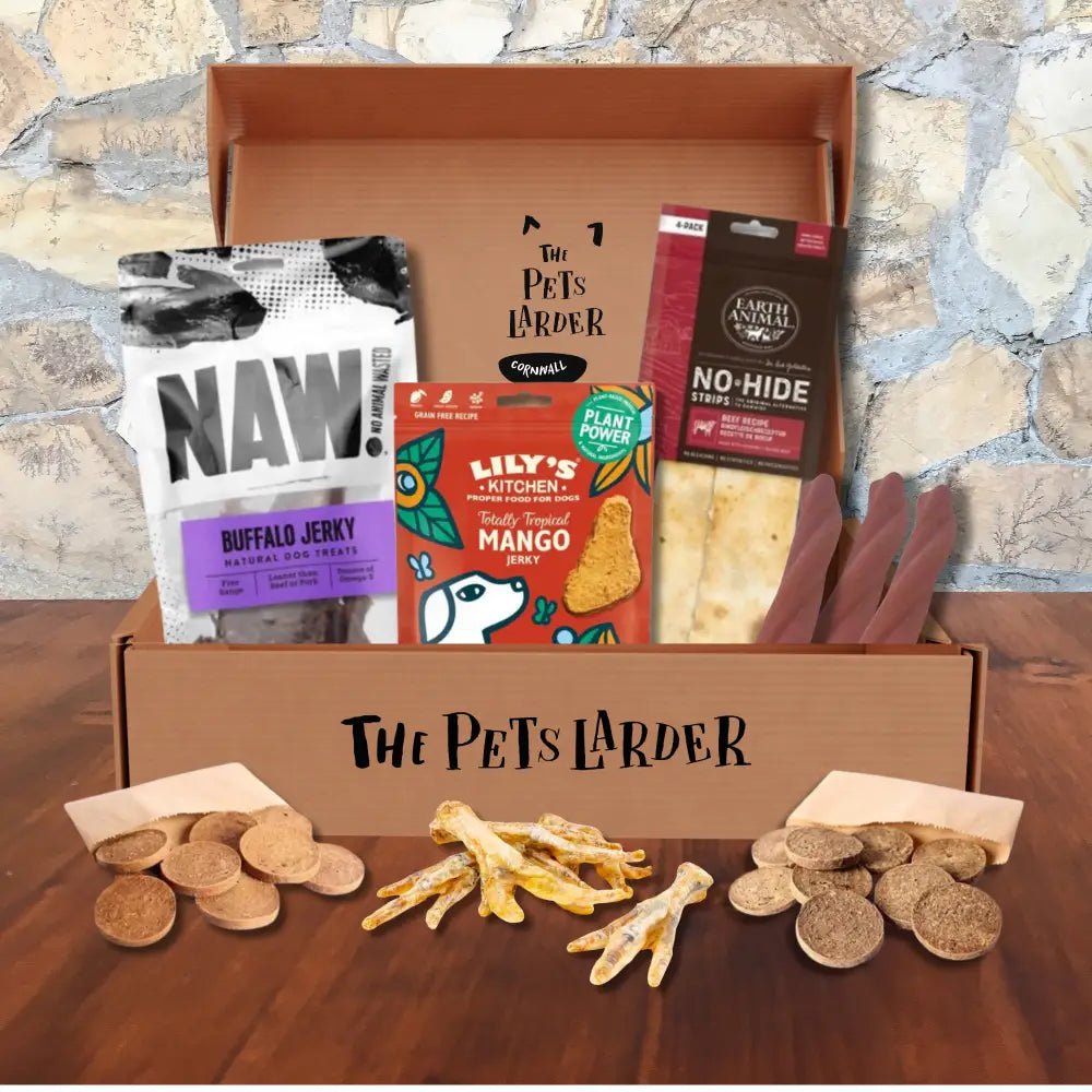Pet treat box with assorted snacks including jerky, bones, biscuits, and creepy cuties rope
