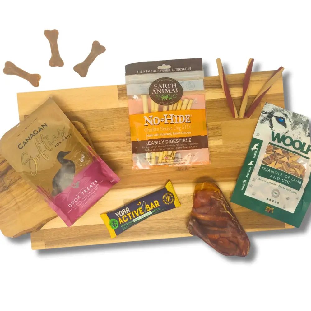 Bamboo dog treat tray with compartments and bone-shaped cutouts for monthly treat boxes