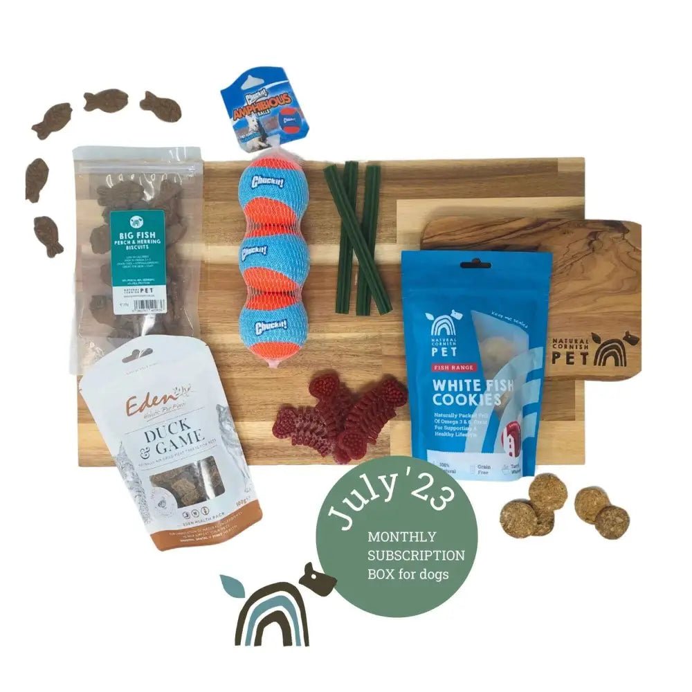 Wooden cutting board with pet treats and creepy cuties rope toy for The Pets Larder monthly treat box