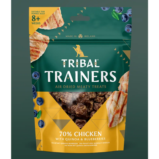 Tribal Trainers dog treat package with chicken, quinoa, and blueberry ingredients on a green background.