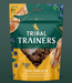 Tribal Trainers dog treat package with chicken, quinoa, and blueberry ingredients on a green background.
