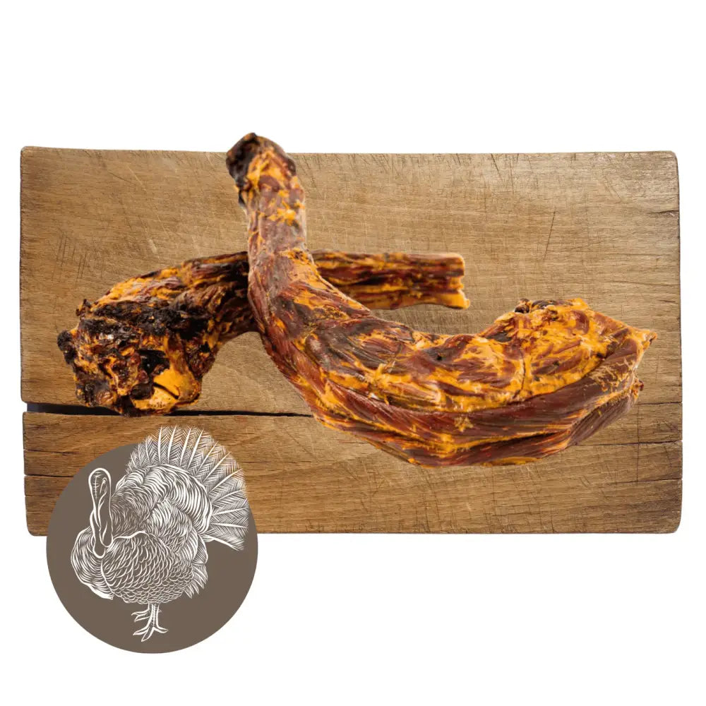 Wooden board with charred banana slices and turkey silhouette for Pets Larder Turkey neck chews
