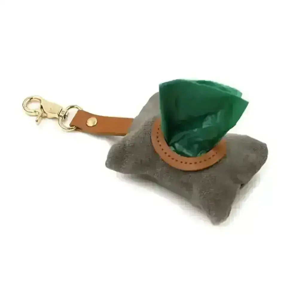 Gray waxed canvas poop bag holder with green liner, tan leather strap, gold clip