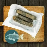Wolf fish stick chew box with dried wolf fish in white paper on wooden board