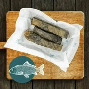 Wolf fish stick chew box with dried wolf fish in white paper on wooden board