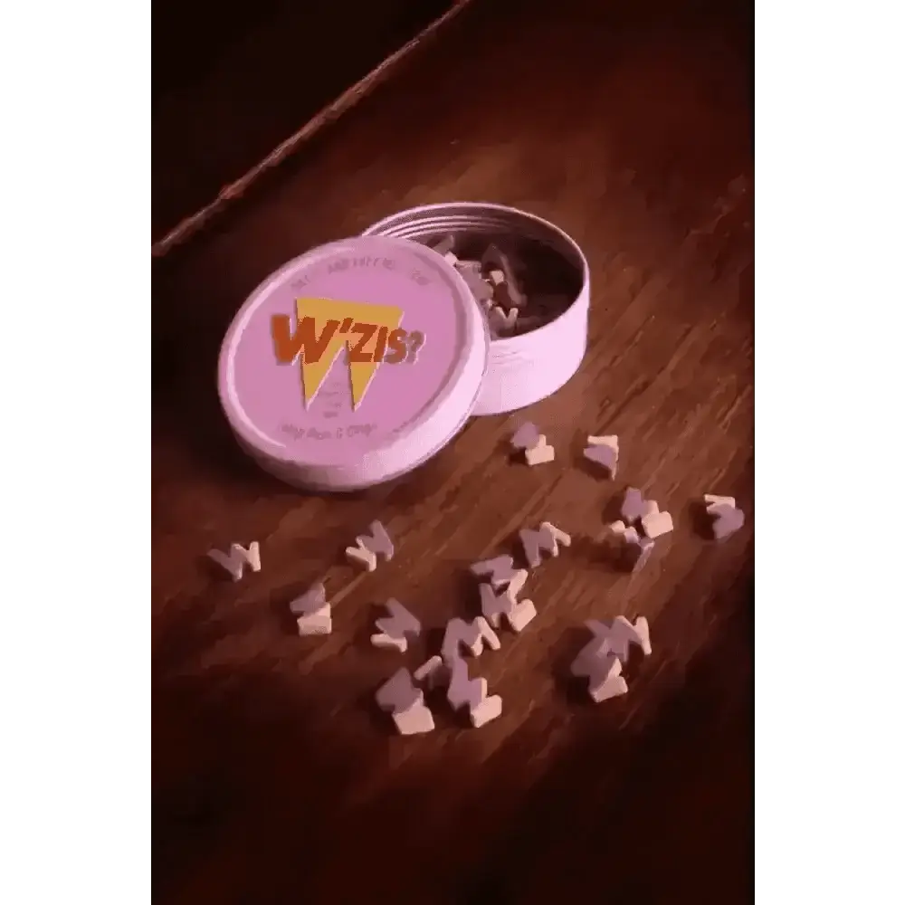 Pink W’ZIS? tin with yellow bolt, purple letters, plant-based treats