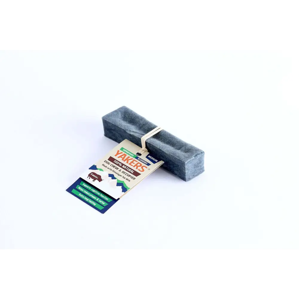 Charcoal gray rectangular dog chew with green and white striped packaging, featuring superfood blueberry