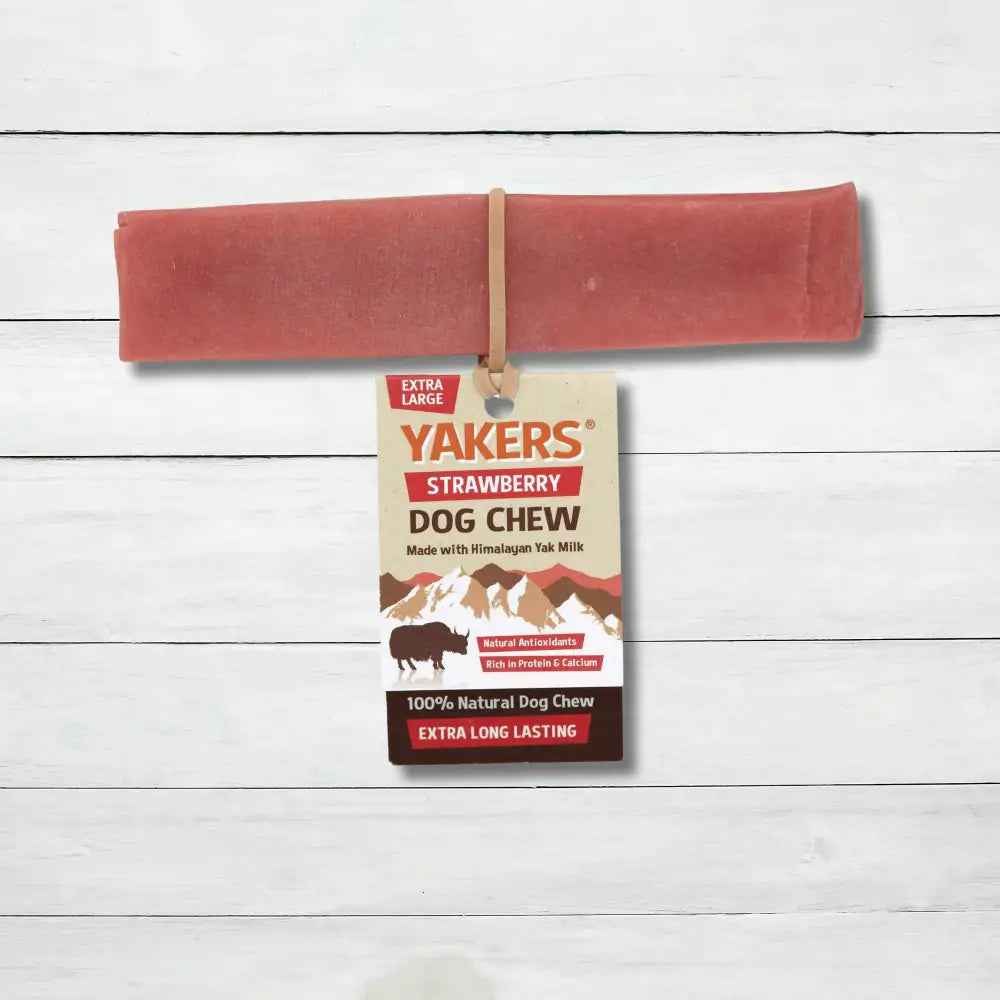 Yakers Strawberry Yak Chew sits on a rustic background. This product can be bought at The Pets Larder natural pet store