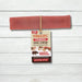 Yakers Strawberry Yak Chew sits on a rustic background. This product can be bought at The Pets Larder natural pet store