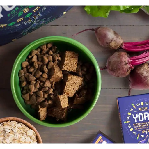 Yora wet food for dogs seen in a green bowl on top of Yora dry food for dogs