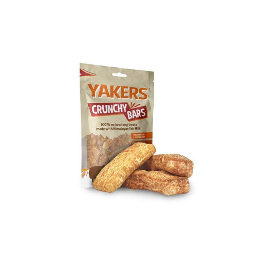 Yakers Crunchy Bars sits on a white background with three loose Crunchy Bars in the foreground